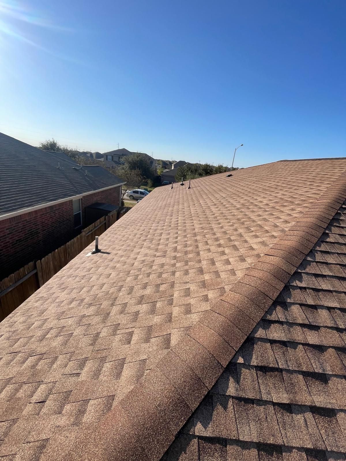 New architectural shingle roof with ridge vent and clean flashing